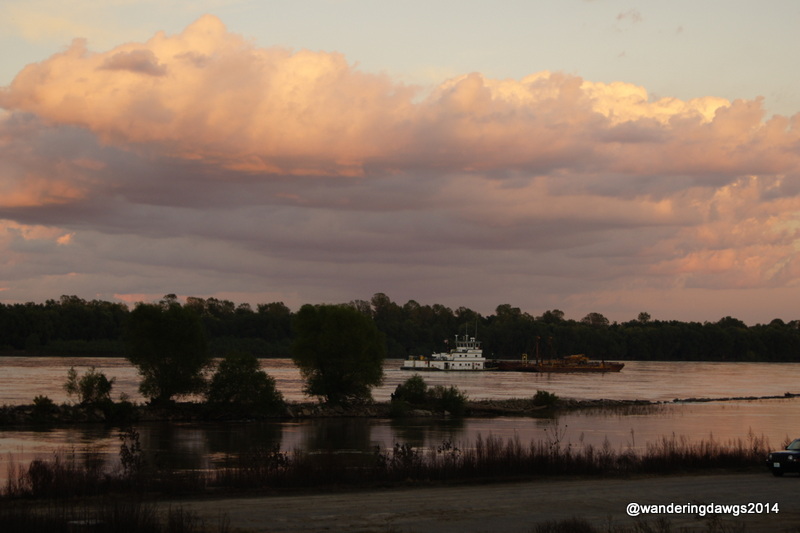 Barge going down the river at sunset